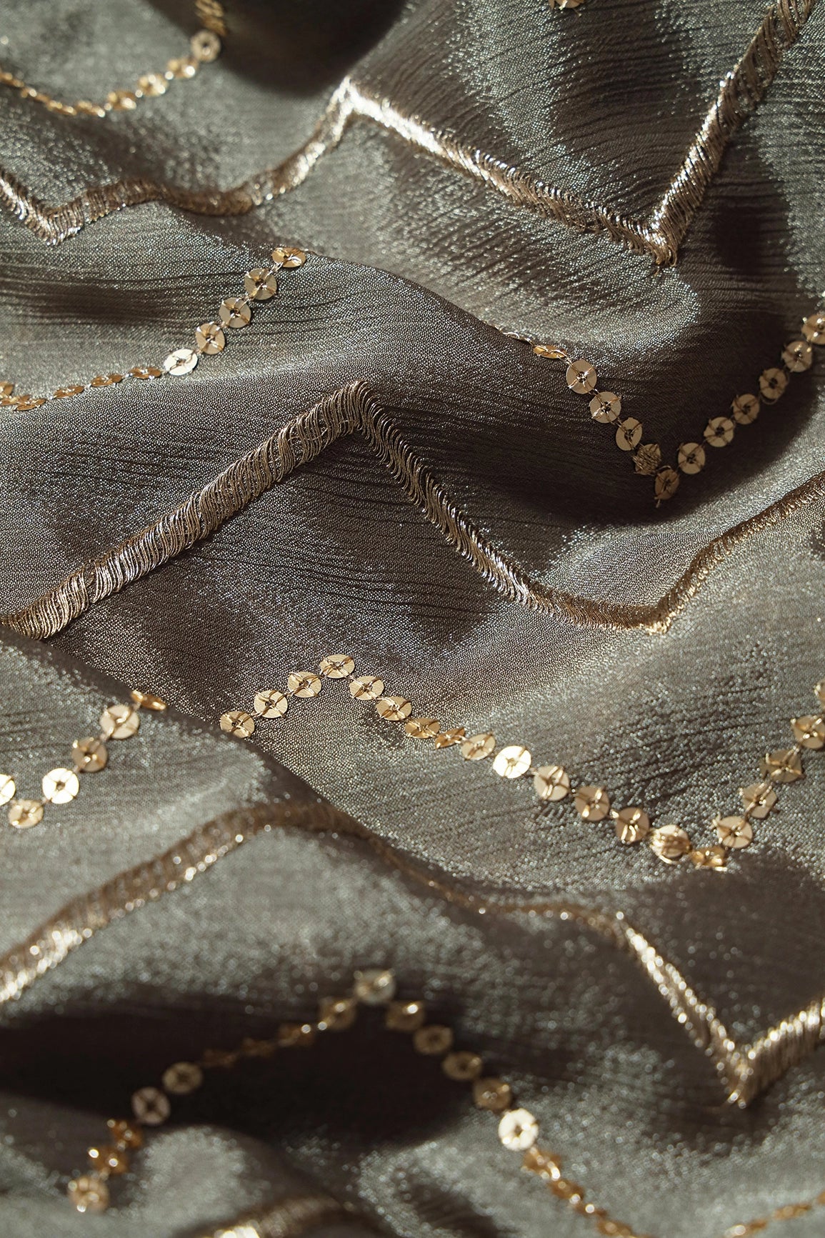 Gold Zari With Gold Sequins Chevron Embroidery Work On Stone Grey Chinnon Chiffon Fabric