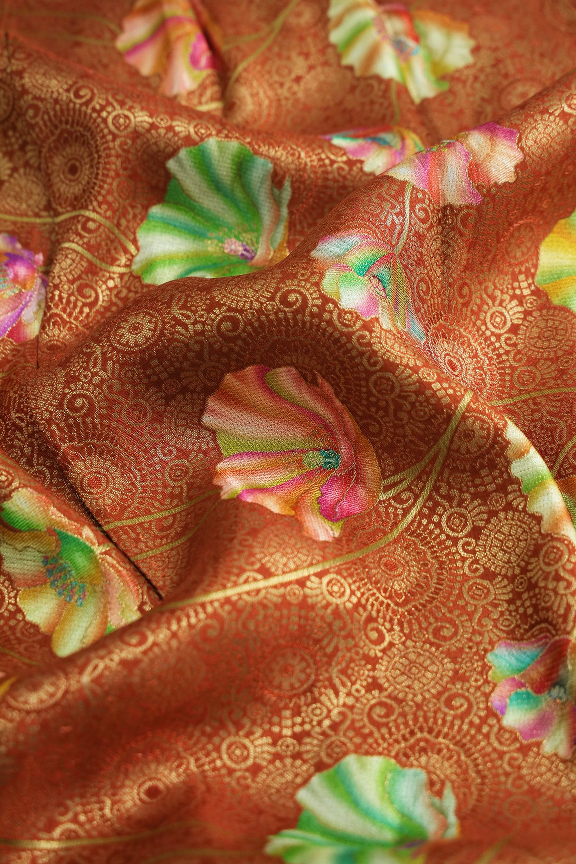 Positional Print On Rust Viscose Dola Silk Jacquard Fabric