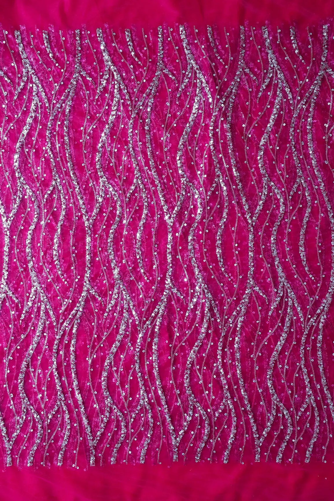 Gold And Silver Sequins With Fuchsia Thread Wavy Embroidery Work On Fuchsia Soft Net Fabric - doeraa