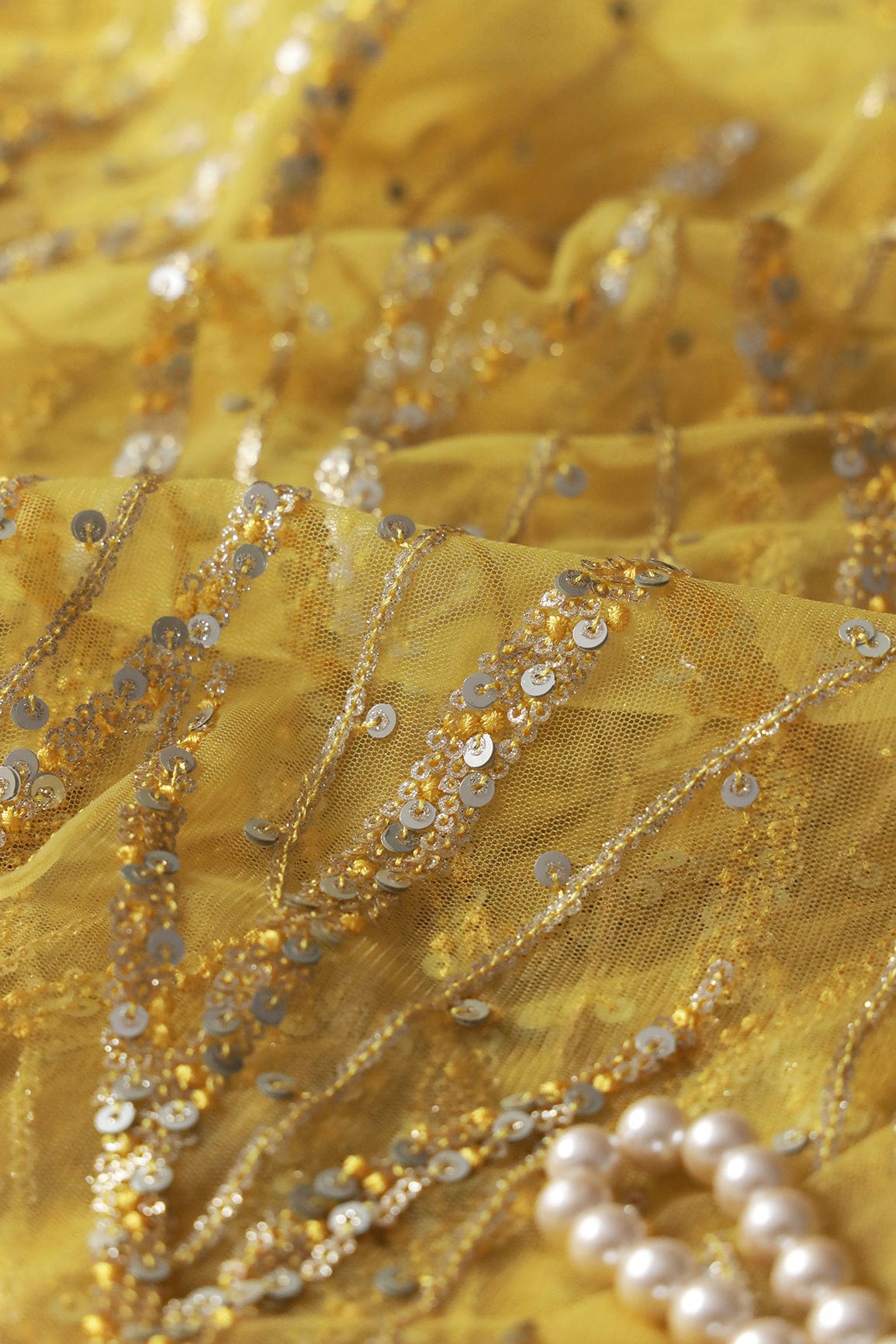 Gold And Silver Sequins With yellow Thread Wavy Embroidery Work On yellow Soft Net Fabric - doeraa