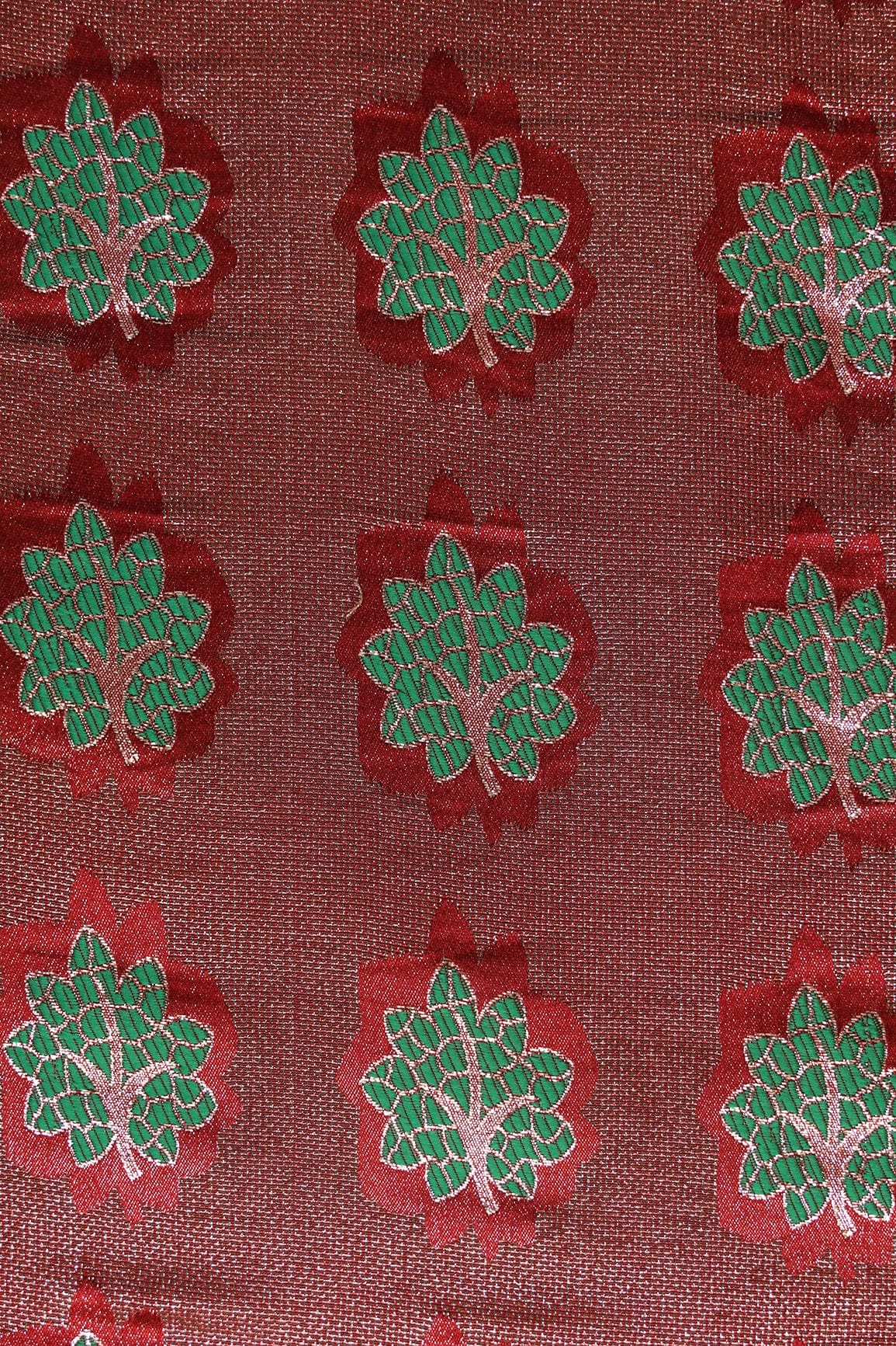 Maroon And Green Leafy Jute Banarasi Zari Jacquard Fabric - doeraa